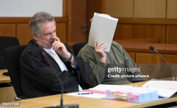 June 2018, Germany, Hagen: The defendant Werner S. Sitting on the dock of the district court during the trial beside his defender Michael Asshauer ....