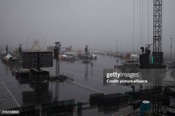 June 2018, Germany, Nuremberg: Pouring rain pouring onto the grounds of the music festival "Rock am Ring" before its opening. About 80 bands are...