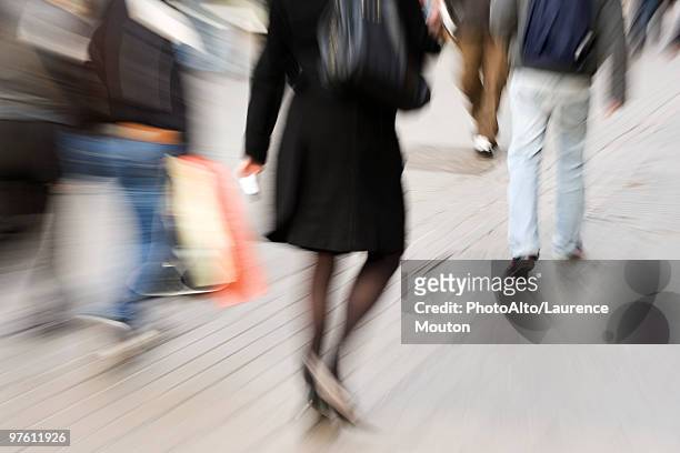 pedestrians walking on sidewalk, rear view, blurred - mitziehen stock-fotos und bilder