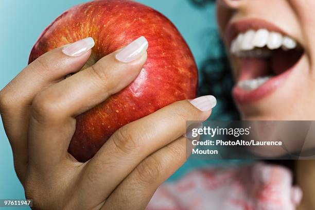 woman eating apple, close-up - adult female eating an apple stock pictures, royalty-free photos & images