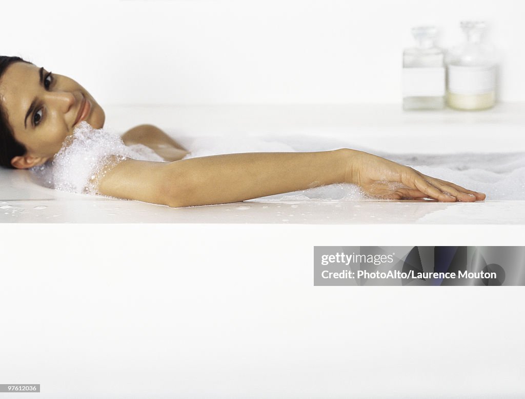 Woman relaxing in bubble bath