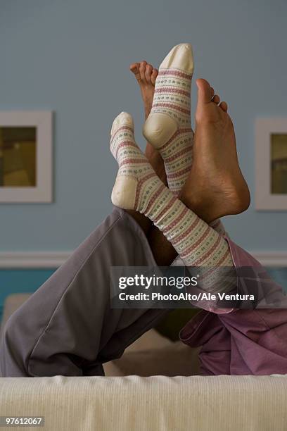 legs raised, intertwined - playing footsie stock pictures, royalty-free photos & images