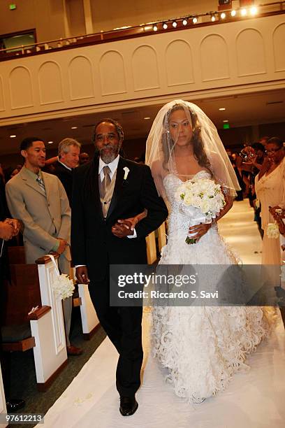Sanya Richards walks down the aisle with her father at her wedding on February 26, 2010 in Austin, Texas.
