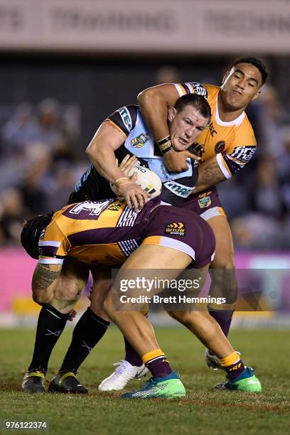 Paul Gallen of the Sharks is tackled during the round 15 NRL match between the Cronulla Sharks and the Brisbane Broncos at Southern Cross Group...