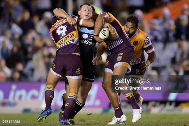 Paul Gallen of the Sharks is tackled during the round 15 NRL match between the Cronulla Sharks and the Brisbane Broncos at Southern Cross Group...