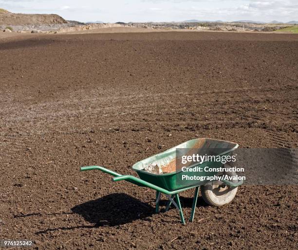 Wheelbarrow on brownfield, UK.