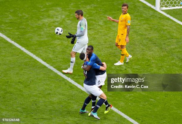 Paul Pogba of France celebrates with teammate Olivier Giroud after scoring his team's second goal, as Mathew Ryan of Australia lookds dejected during...