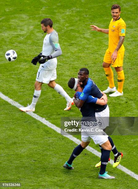 Paul Pogba of France celebrates with teammate Olivier Giroud after scoring his team's second goal, as Mathew Ryan of Australia lookds dejected during...