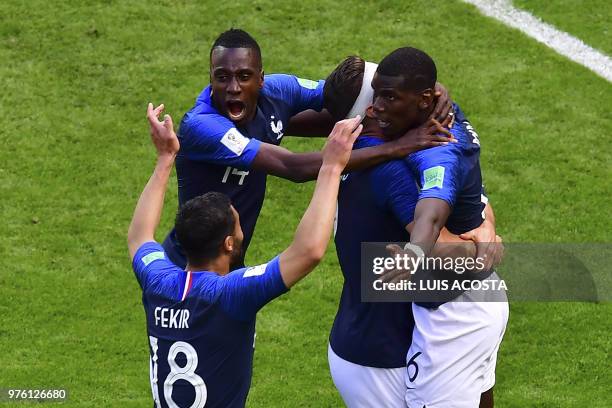 France's players hug France's midfielder Paul Pogba to celebrate after scoring their second goal during the Russia 2018 World Cup Group C football...