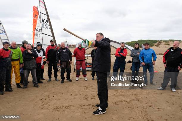 Competitors listen to a race briefing during the National Land Sailing regatta held on Coatham Sands on June 16, 2018 in Redcar, England. Land...