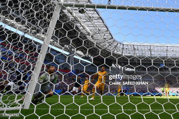Australia's goalkeeper Mathew Ryan eyes the ball bouncing in his goal as France's midfielder Paul Pogba celebrates after scoring their second goal...