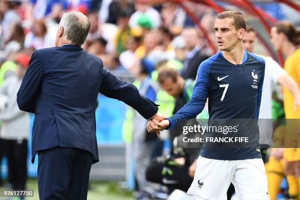 France's coach Didier Deschamps takes France's forward Antoine Griezmann's hand during the Russia 2018 World Cup Group C football match between...