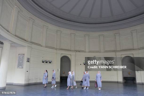 Group of nuns walks inside the Elisenbrunnen monument in Aachen, western Germany, on June 15, 2018.