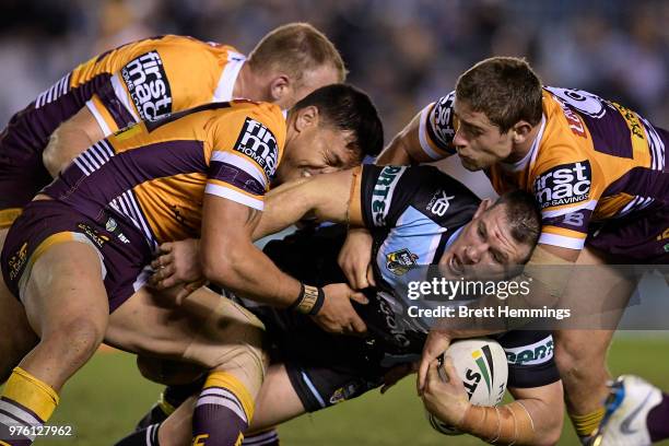 Paul Gallen of the Sharks is tackled during the round 15 NRL match between the Cronulla Sharks and the Brisbane Broncos at Southern Cross Group...