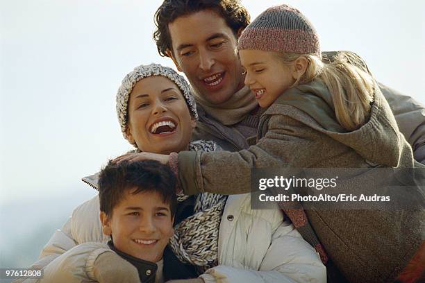 family laughing together outdoors, daughter ruffling her brother's hair - ruffling stock pictures, royalty-free photos & images