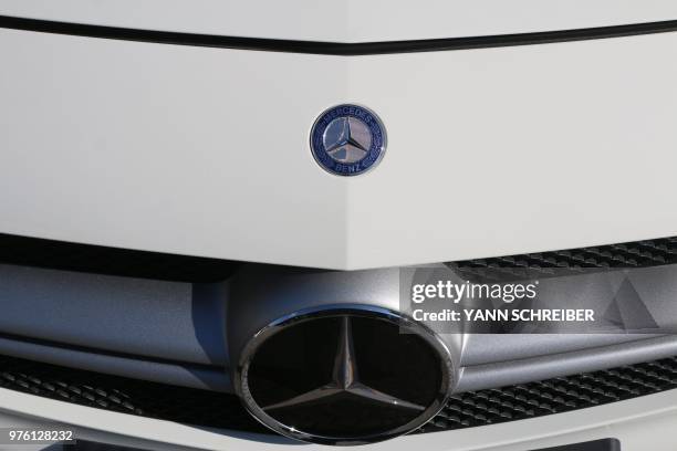 In this file picture taken on June 15, 2018 The logo of Mercedes Benz is pictured on a car on display in Aachen, western Germany.