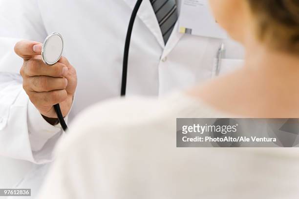 doctor preparing to examine patient using stethoscope - film festival screening of behind the curve stockfoto's en -beelden