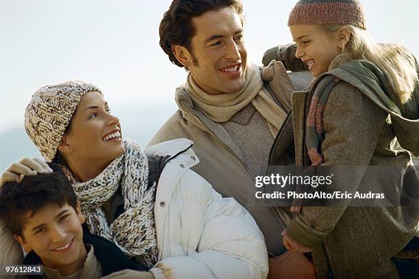 family outdoors, father carrying daughter, mother ruffling son's hair - ruffling stock pictures, royalty-free photos & images