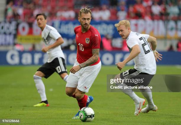 June 2018, Austria, Klagenfurt: Soccer international friendly, Austria vs Germany at the Woerthersee Stadium. Austria's Peter Zulj in a duel with...