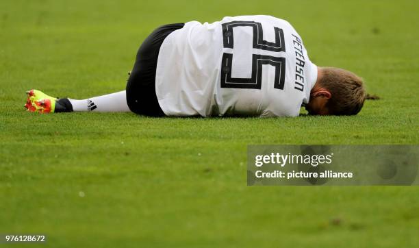 June 2018, Austria, Klagenfurt: Soccer international friendly, Austria vs Germany at the Woerthersee Stadium. Germany's Nils Petersen lies injured on...