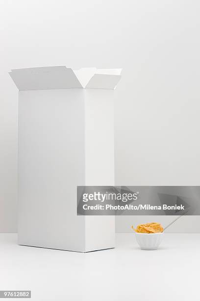 food concept, cereal box with small bowl of cereal - breakfast cereal stock pictures, royalty-free photos & images