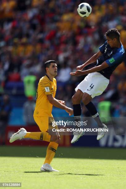 France's defender Raphael Varane heads the ball past Australia's midfielder Tomas Rogic during the Russia 2018 World Cup Group C football match...