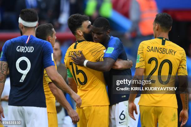 France's midfielder Paul Pogba and Australia's midfielder Mile Jedinak exchange an embrace following the Russia 2018 World Cup Group C football match...