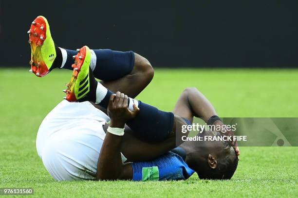 France's midfielder Paul Pogba lies on the field after resulting injured during the Russia 2018 World Cup Group C football match between France and...