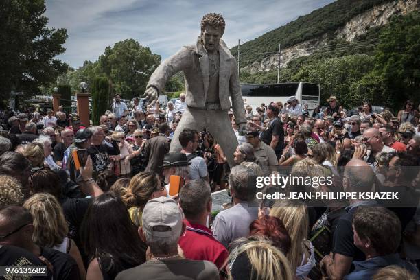 Fans attend the inauguration of a statue of late French rocker Johnny Hallyday by French sculptor Daniel Georges set up in the Southeastern French...