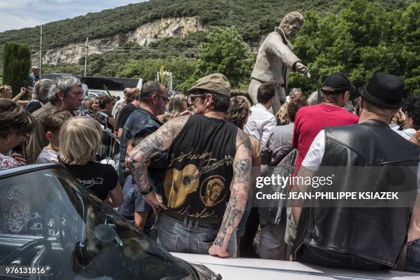 Fans attend the inauguration of a statue of late French rocker Johnny Hallyday by French sculptor Daniel Georges installed in its position in the...