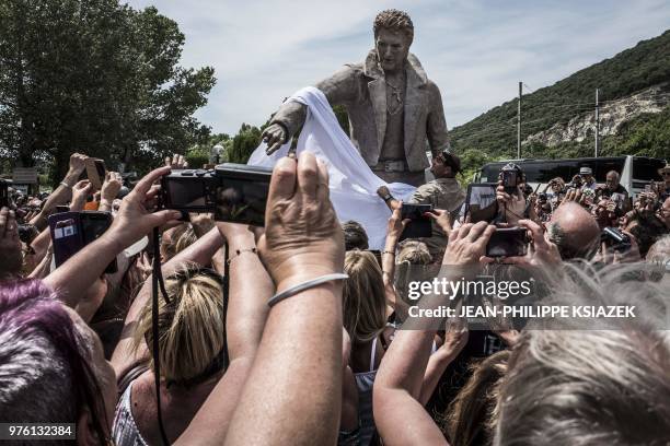 Fans attend the inauguration of a statue of late French rocker Johnny Hallyday by French sculptor Daniel Georges and set up in the southeastern...