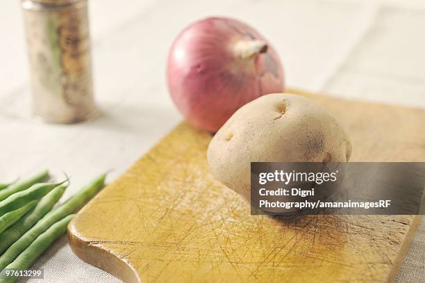 potato, red onion and runner beans on a cutting board - cutting red onion stock pictures, royalty-free photos & images