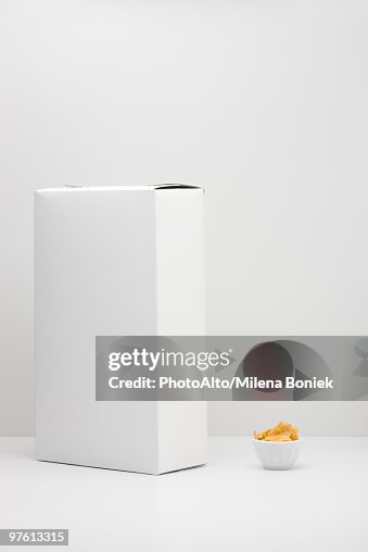 White cereal box and small bowl of cereal White cereal box and small bowl of cereal