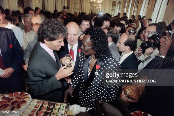 Jazz trumpeter Miles Davis is made a Knight in the French Legion of Honor by French Culture minister Jack Lang in Paris on July 16, 1991.