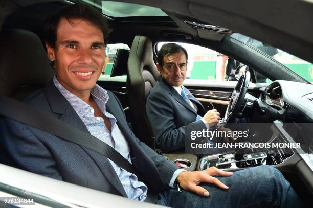 Spanish tennis player Rafael Nadal arrives with Automobile Club de l'Ouest President Pierre Fillon prior to the start of the 86th edition of the Le...