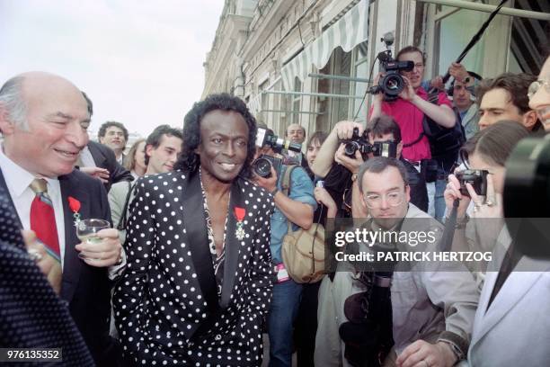 Jazz trumpeter Miles Davis smiles among the crowd after the ceremony which made him a Knight in the French Legion of Honor by French Culture minister...