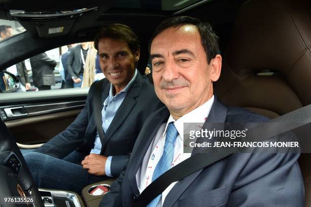 Spanish tennis player Rafael Nadal arrives with Automobile Club de l'Ouest President Pierre Fillon prior to the start of the 86th edition of the Le...