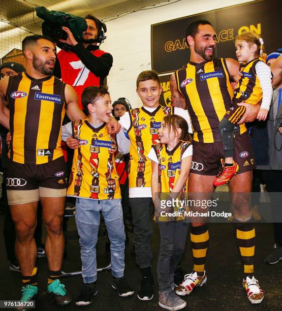 Shaun Burgoyne of the Hawks sing the club song after winning with his kids after his 350th match during the round 13 AFL match between the Hawthorn...