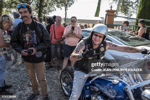 Fans gather on June 16 as they attend the inauguration of a statue of late French rocker Johnny Hallyday set up in the southeastern French village of...