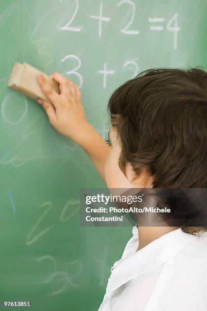 boy erasing blackboard - chalkboard eraser stock pictures, royalty-free photos & images