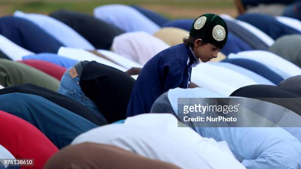 Sri Lankan Muslim boy attends Eid al Fitr prayers among the adults at Galle Face, Colombo, Sri Lanka on Saturday June 2018. Eid al-Fitr marks the end...