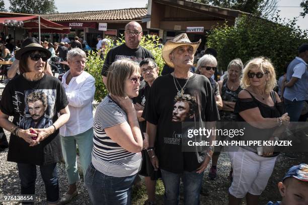 People gather on June 16 as they attend the inauguration of a statue of late French rocker Johnny Hallyday set up in the southeastern French village...