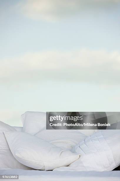 pillows against background of clouds in pale sky - travesseiro imagens e fotografias de stock