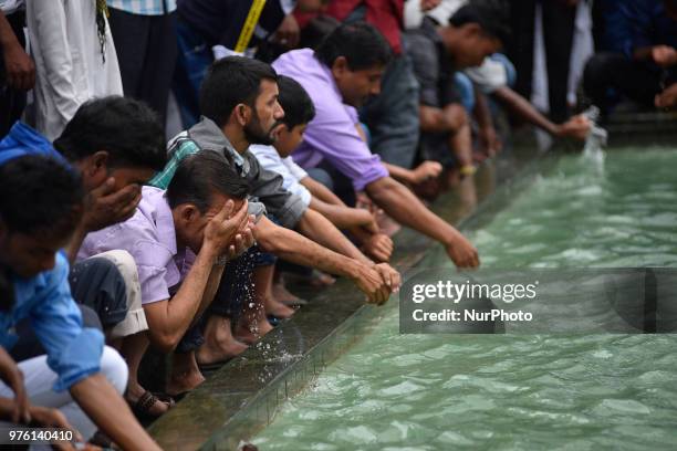 Nepalese Muslims washes his hands, face and feet before offering ritual morning prayers during celebration of Eid al-Fitr at Kashmiri Takiya Jame...