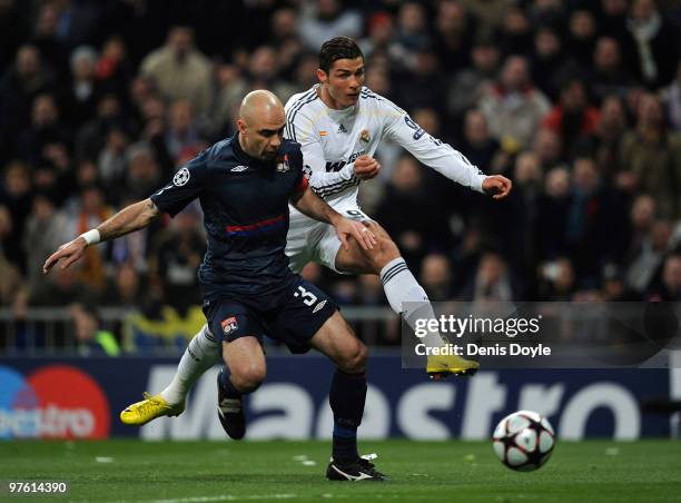 Cristiano Ronaldo of Real Madrid beats Cris of Olympique Lyonnais to score Real's first goal during the UEFA Champions League round of 16 2nd leg...