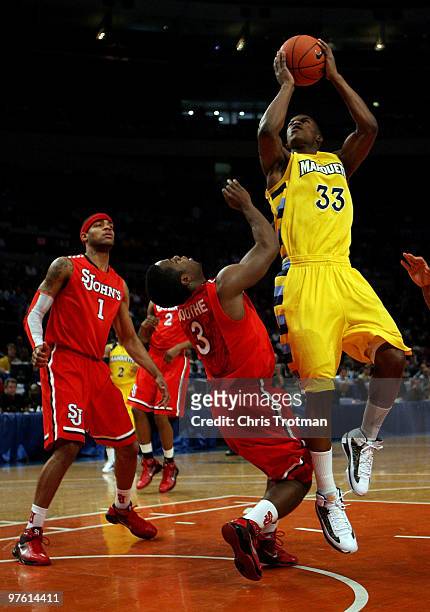 Jimmy Butler of the Marquette Golden Eagles goes to the hoop against Malik Boothe of the St. John's Red Storm during the second round of 2010 NCAA...