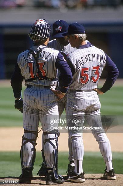 Catcher Jim Leyritz and pitching coach Marcel Lachemann speak with pitcher Pep Harris on the mound during the game against the Chicago White Sox at...