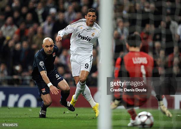 Cristiano Ronaldo of Real Madrid beats Cris of Olympique Lyonnais to score Real's first goal during the UEFA Champions League round of 16 2nd leg...