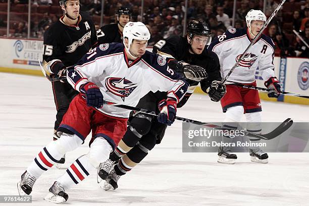Fedor Tyutin of the Columbus Blue Jackets defends against Bobby Ryan of the Anaheim Ducks during the game on March 9, 2010 at Honda Center in...