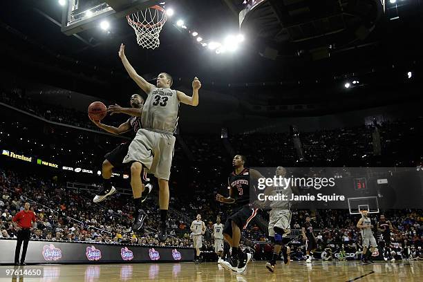 John Roberson of the Texas Tech Red Raiders shoots the ball over Austin Dufault of the Colorado Buffaloes in the second half during the first round...